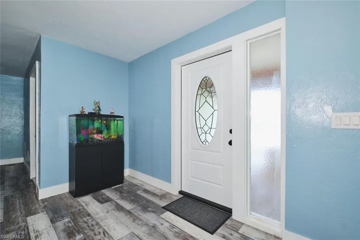 View of main entry into home.  Both the door and side panel are also impact.  No expenses were spared bringing this home to a 2025 home!