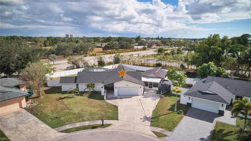 This property is .35 acres.  Don't find that too often.  Lot is 60X120X200X110.  Fenced in yard houses a HUGE backyard, in-ground pool and there is an attached in-law suite or apartment.  Total impact windows throughout minus the in-law suite.  Parking for about 7 cars.  Situated on a cul-de-sac.