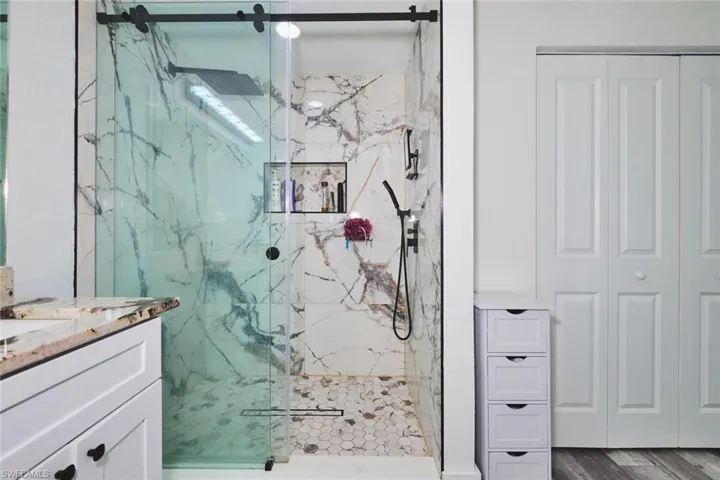 Full shower view.  Farm door, nook for essentials, nice hardware.  Makes for a nice shower.