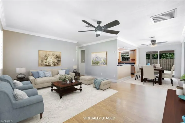 Living room with light hardwood / wood-style floors, ornamental molding, sink, and ceiling fan