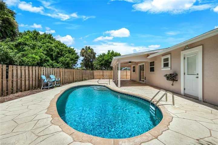 View of swimming pool with a patio area and ceiling fan