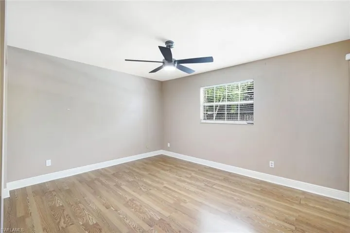 Spare room with ceiling fan and light hardwood / wood-style floors