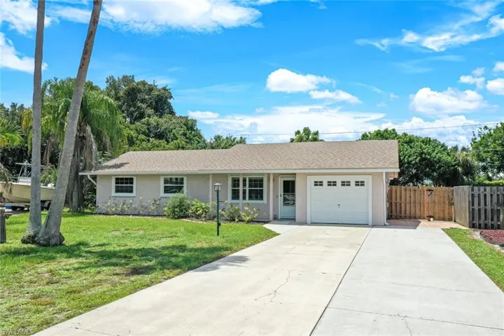 Ranch-style home with a garage and a front yard