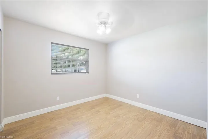 Empty room featuring light wood-type flooring and ceiling fan