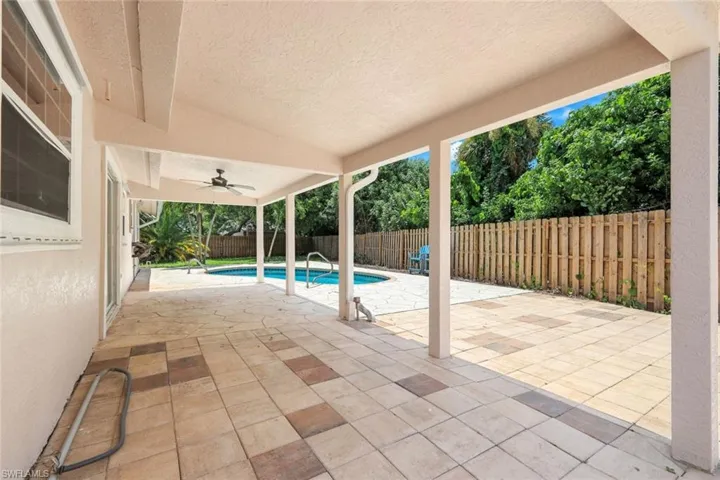 View of swimming pool with a patio and ceiling fan