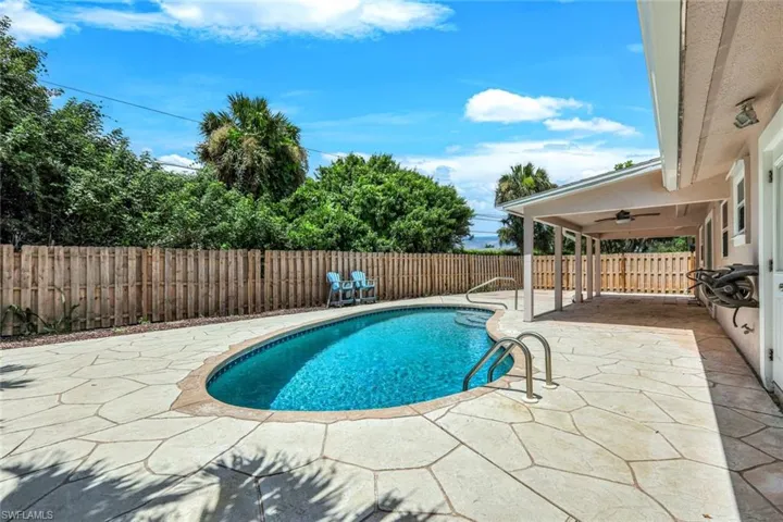 View of pool featuring a patio area and ceiling fan