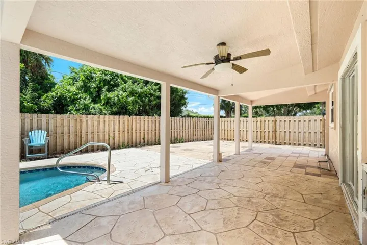 View of patio featuring a fenced in pool and ceiling fan