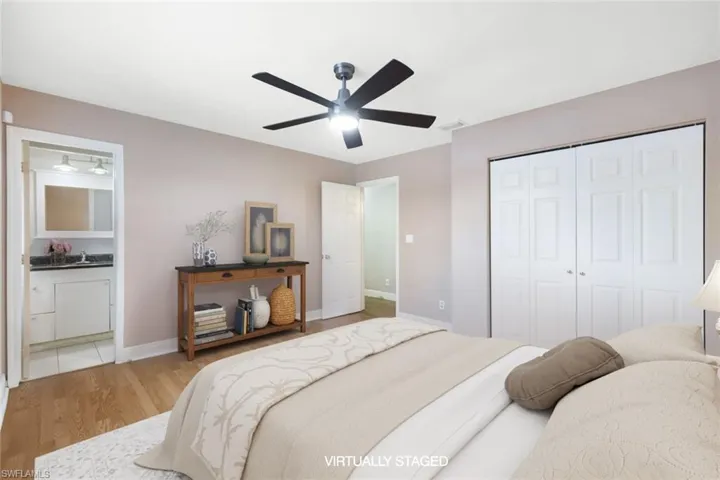 Bedroom with a closet, ceiling fan, and light wood-type flooring