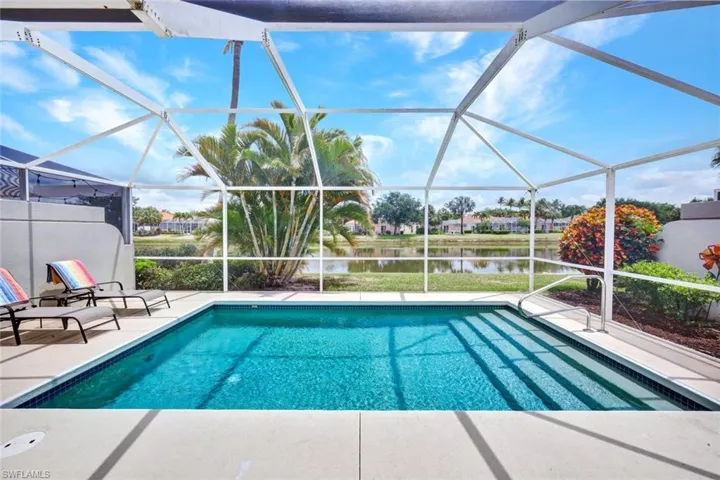 Screened lanai featuring a swimming pool with integrated steps, concrete patio, and direct water frontage