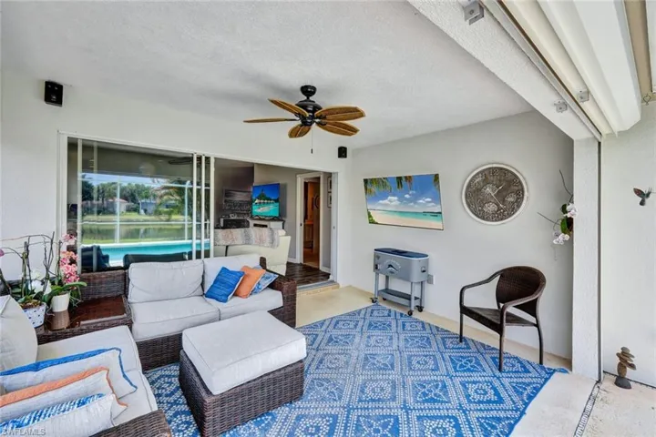 Covered outdoor patio featuring a ceiling fan, recessed lighting, and a large sliding glass door