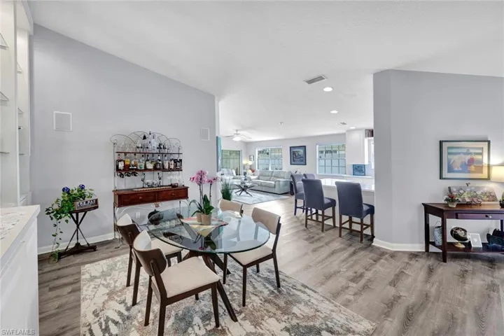 Open concept interior featuring vaulted ceilings and wood-finish flooring