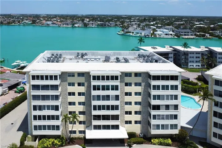Birds eye view of property with a water view