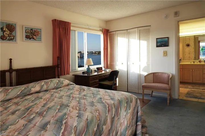 Primary bedroom with sliders to balcony