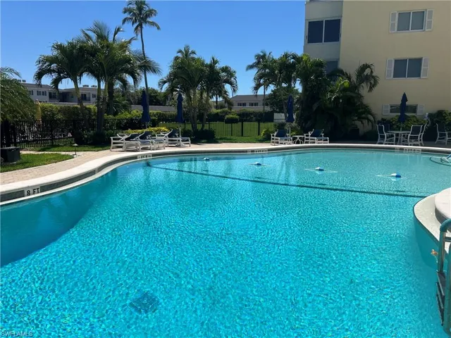 Pool featuring a patio and fence