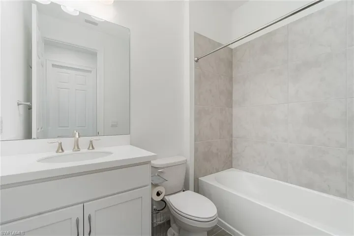 Bathroom with vanity and bathtub / shower combination