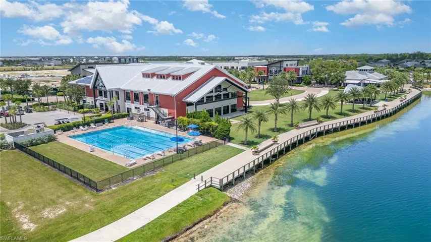 Aerial view of a pool and a nearby body of water