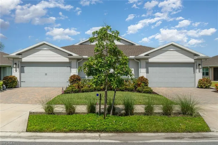 Single story home featuring a garage, decorative driveway, and roof with shingles