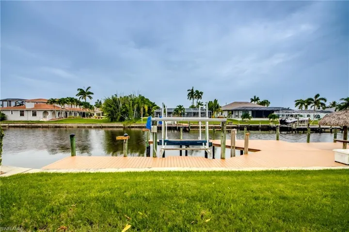 View of dock featuring a yard and a water view