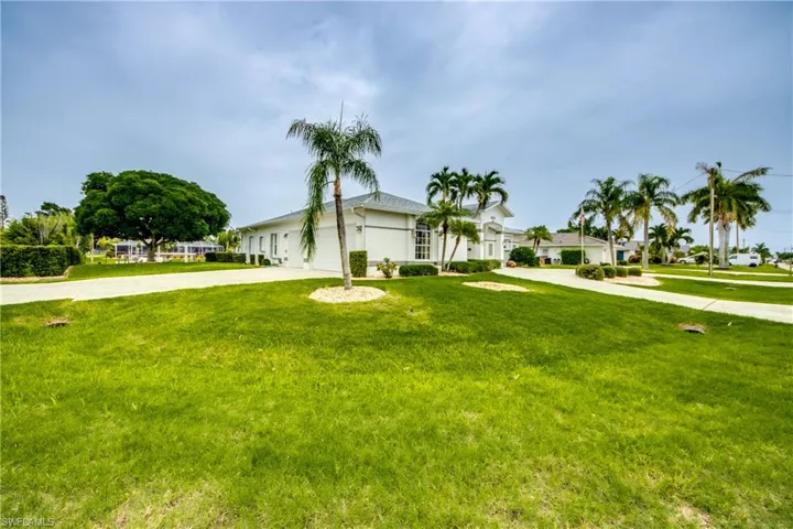 View of front of home featuring a front lawn and TWO LARGE DRIVEWAYS