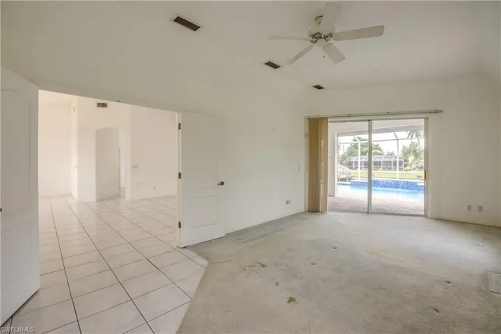 Master Bedroom with light colored carpet and ceiling fan.  Double Door Entry