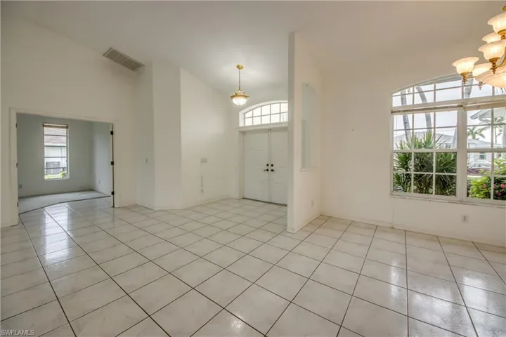 Looking back to Front Doors and into Master Bedroom to the left with Double Door Entry