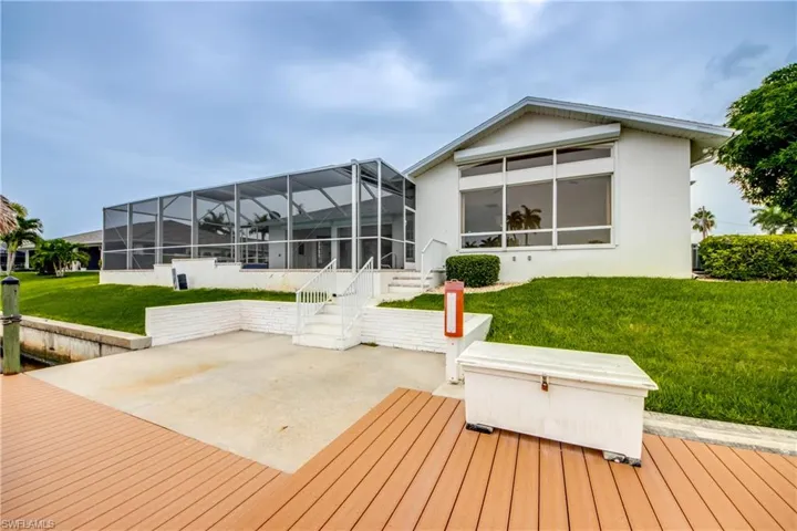 Back of house featuring a lanai, a patio area, and a lawn.  View from Dock !