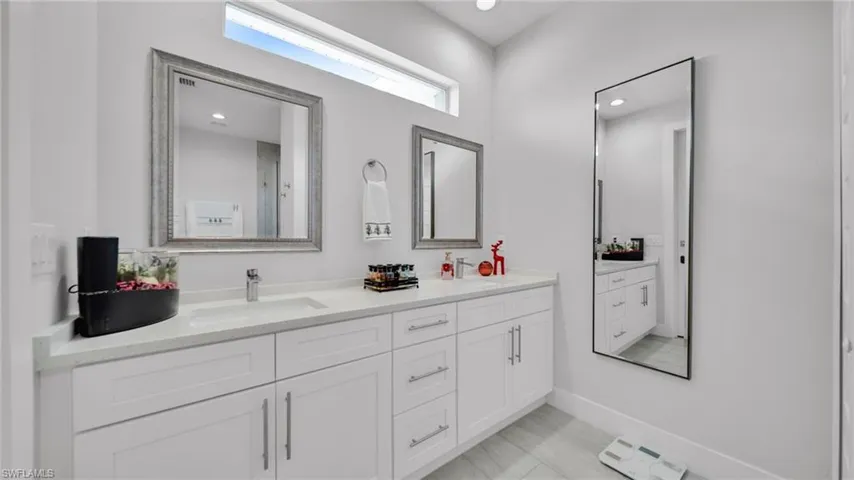Bathroom with double vanity and recessed lighting