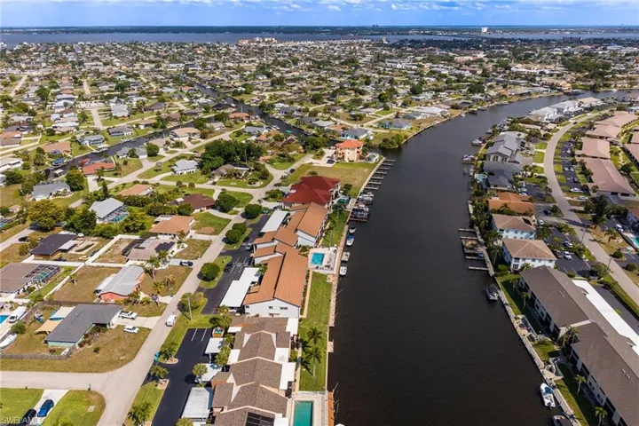 Expansive aerial view of a residential neighborhood featuring numerous canals