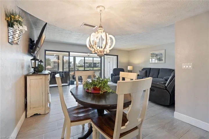 Dining area featuring a decorative chandelier and light wood-finish flooring