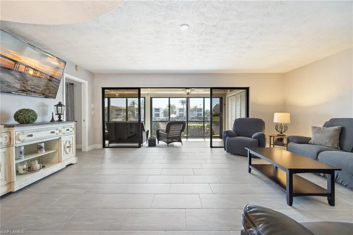 Open concept living area featuring light-toned plank-style flooring