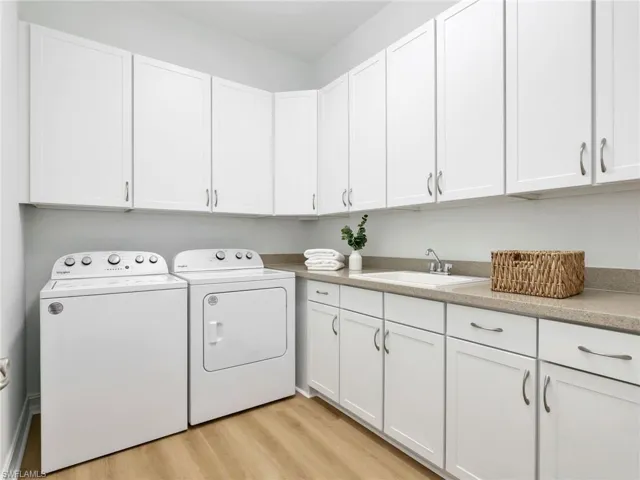 Expansive Laundry Room w/ extensive cabinetry and convenient sink