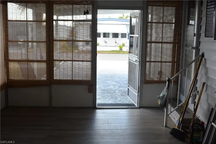 Doorway featuring healthy amount of natural light and wood finished floors