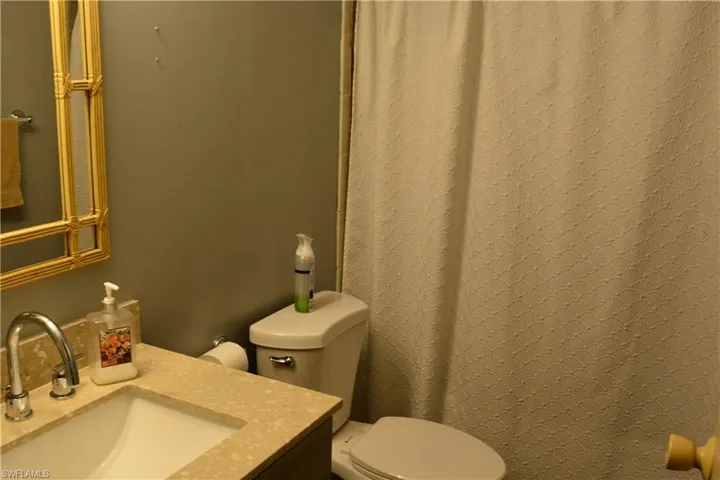 Guest bath featuring vanity and a shower with shower curtain