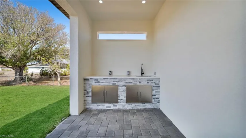 View of patio with exterior kitchen and a sink