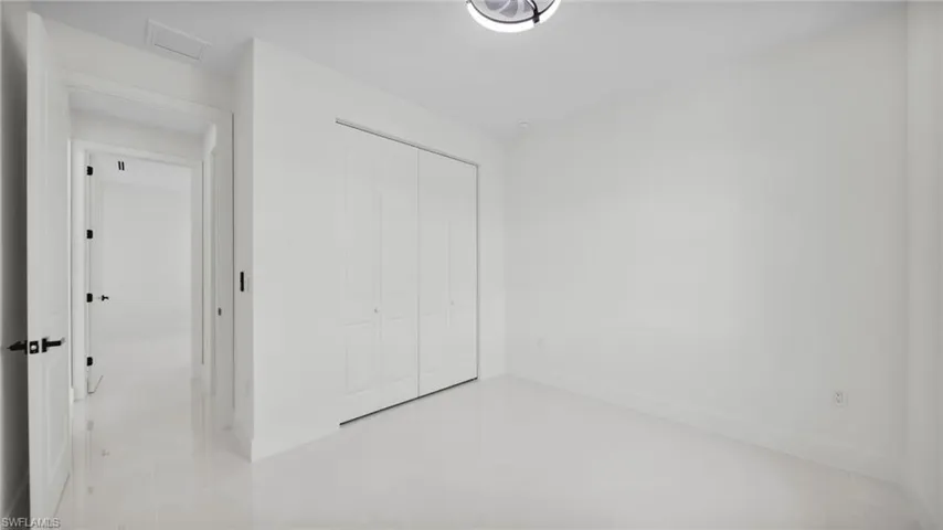 Unfurnished bedroom with a closet and baseboards
