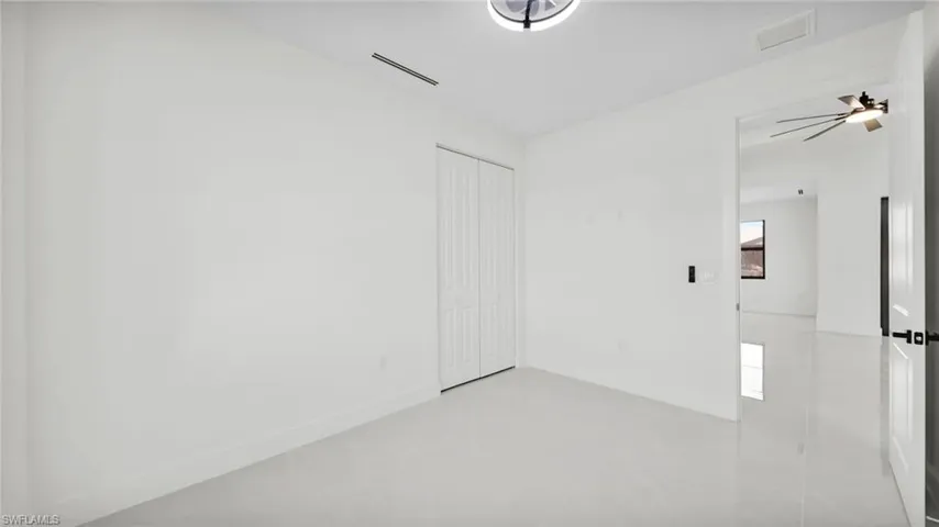 Unfurnished bedroom with a closet and light tile patterned floors