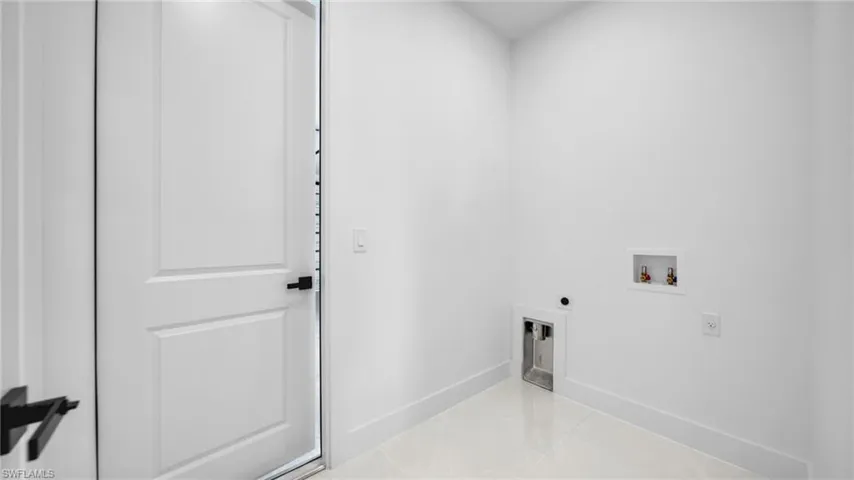 Laundry room featuring hookup for an electric dryer, washer hookup, and light tile patterned floors