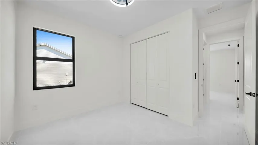 Unfurnished bedroom with a closet and baseboards