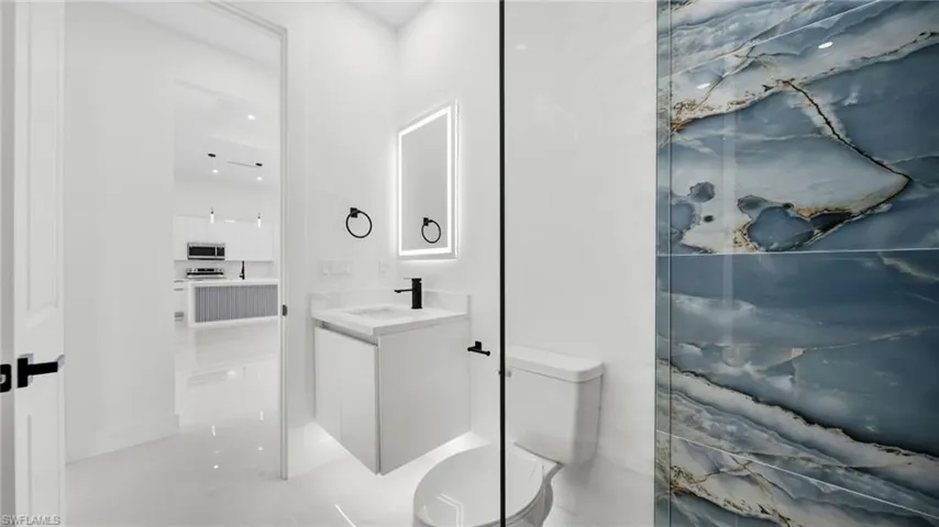 Bathroom with vanity and recessed lighting