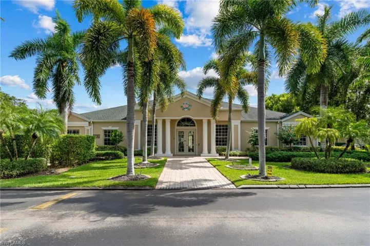 View of front of clubhouse featuring a front lawn and french doors