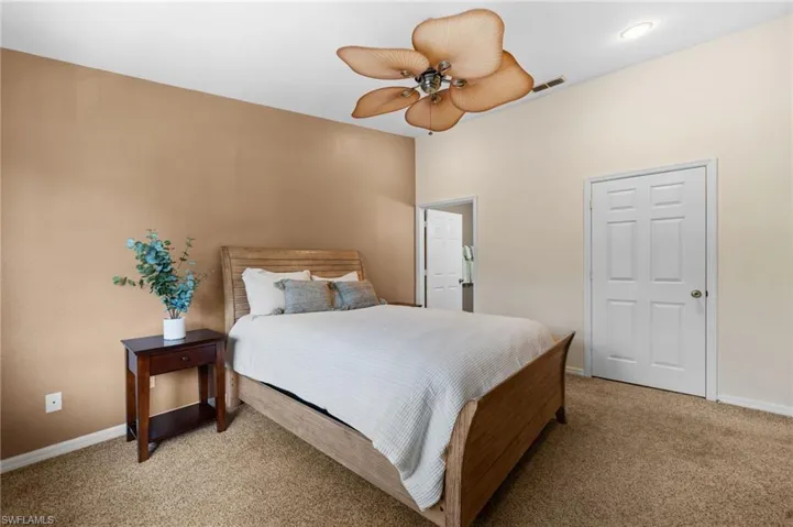 Carpeted bedroom with ceiling fan