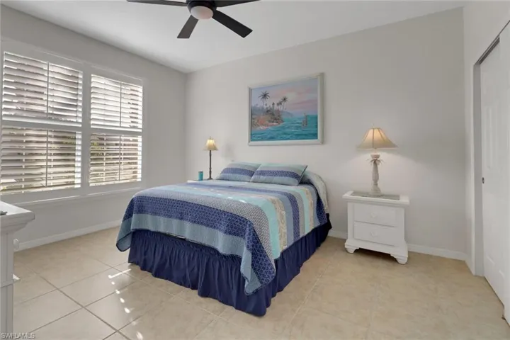 Bedroom featuring ceiling fan, a closet, and light tile patterned flooring