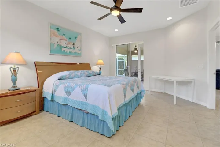 Primary Bedroom featuring access to exterior, ceiling fan, and light tile patterned floors