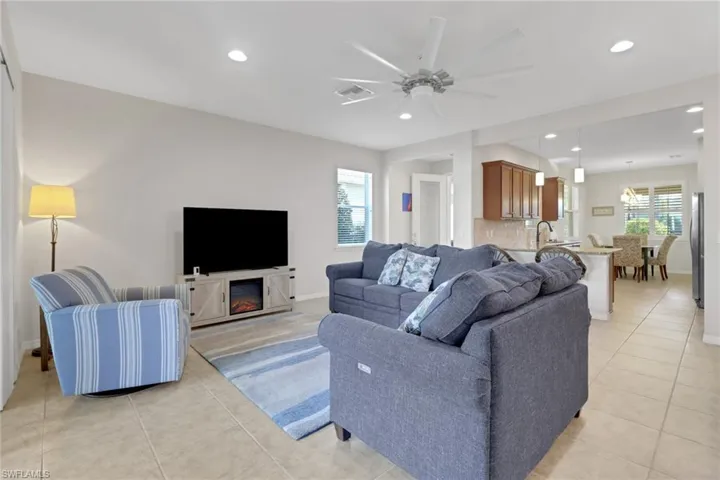 Tiled living room featuring ceiling fan