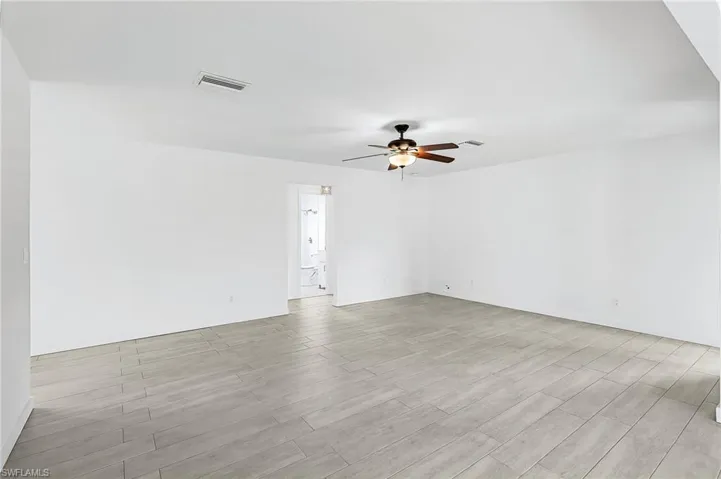 Unfurnished room featuring a ceiling fan and light wood-style flooring