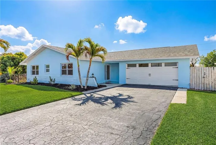 Single story home with stucco siding, driveway, an attached garage, and a shingled roof