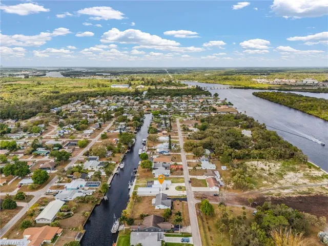 Aerial perspective of suburban area with a nearby body of water