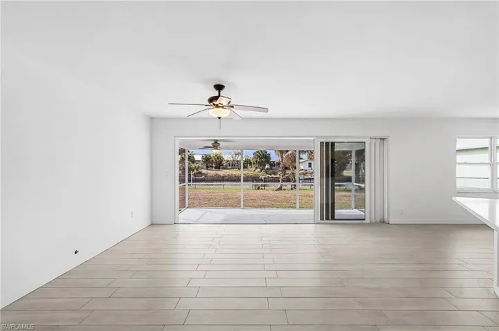 Unfurnished room featuring a ceiling fan and wood finish floors