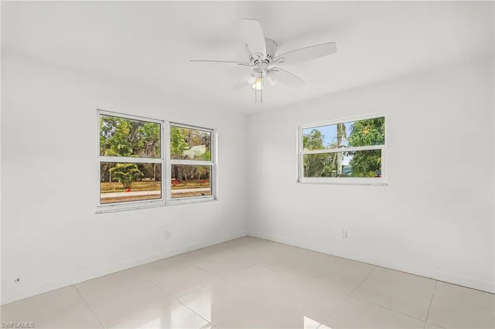 Spare room featuring ceiling fan and light tile patterned flooring