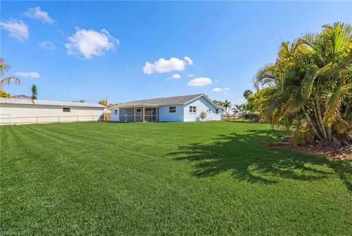 Rear view of house featuring a sunroom